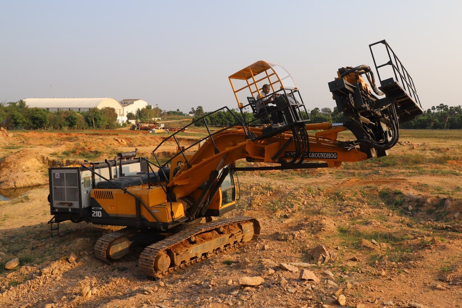 Velson Ground Hog horizontal drill on an excavator carrier, operator at the canopied station with the drill head raised clear of the boom